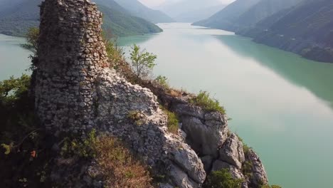Aerial-Over-An-Abandoned-Ruin-On-Lake-Zhinvali-In-The-Republic-Of-Georgia-1