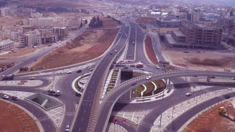 Vista-Aérea-Tilt-Down-Of-Traffic-Circle-Or-Roundabout-With-Car-Traffic-Amman-Jordan