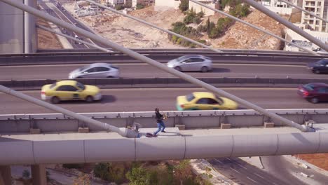 Aerial-Of-A-Man-Playing-Saxophone-On-The-Abdoun-Bridge-In-Amman-Jordan