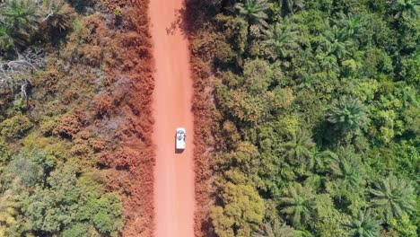 Aerial-Over-A-White-Van-Driving-The-Jungle-Backroads-Of-West-Africa-In-Guineabissau-1