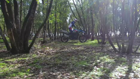 A-Dirt-Bike-Motorcycle-Rider-Drives-Through-A-Forest-Area-1