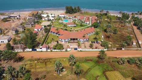 Vista-Aérea-Over-A-Hotel-Or-Large-Estate-On-The-Coast-Of-Gambia-West-Africa