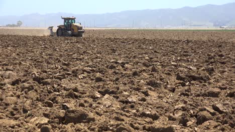 Farm-Tractor-Moves-Across-Dry-Dusty-Landscape-In-California-Suggesting-Drought-And-Climate-Change-4