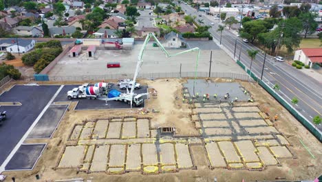 Remarkable-Aerial-Over-Construction-Site-With-Giant-Crane-And-Workers-Pouring-Concrete-Foundation-In-Ventura-California-3