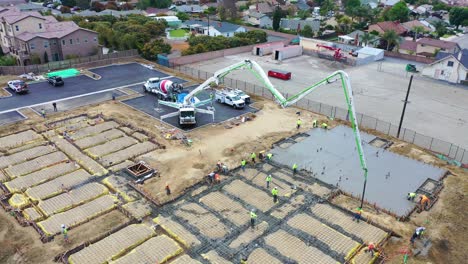 Remarkable-Aerial-Over-Construction-Site-With-Giant-Crane-And-Workers-Pouring-Concrete-Foundation-In-Ventura-California-5