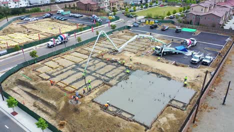 Remarkable-Aerial-Over-Construction-Site-With-Giant-Crane-And-Workers-Pouring-Concrete-Foundation-In-Ventura-California-6
