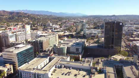Aerial-Of-Downtown-Hollywood-California-With-The-Hollywood-Hills-And-Griffith-Observatory-Distant