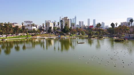 Aerial-Of-Macarthur-Park-Lake-Near-Downtown-Los-Angeles-California-Wishire-District-With-City-Skyline-Background