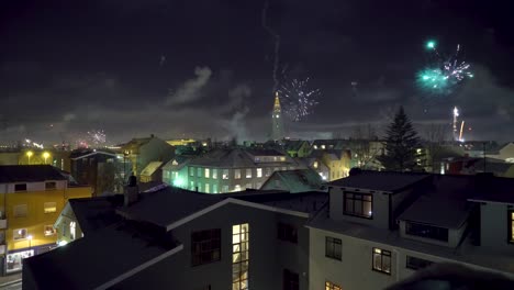 Fireworks-go-off-on-New-Year's-Eve-in-Reykjavik-Iceland-with-the-Hallgrimskirkja-church-in-sight