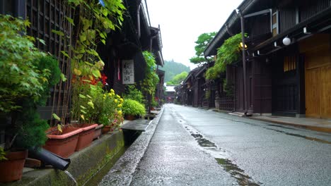 A-rainy-Sanmanchi-Suji-street-is-seen-in-Takayama-Japan-and-rainwater-fills-a-gutter