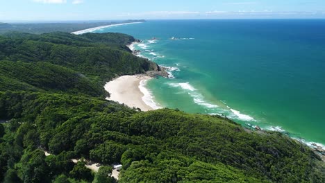 An-Aerial-View-Shows-Waves-Lapping-At-Whites-Beach-In-Byron-Bay-Australia