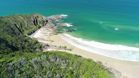 An-Aerial-View-Shows-Waves-Lapping-At-Whites-Beach-In-Byron-Bay-Australia-1