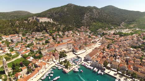 An-Aerial-View-Shows-The-Port-Town-Of-Hvar-Croatia-With-Boats-Docked-In-The-Harbor