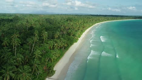 An-Aerial-View-Shows-Waves-Lapping-At-Madwaer-Beach-In-Maluku-Indonesia