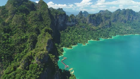 An-Aerial-View-Shows-Green-Mountains-And-Harbor-Lodgings-At-Khao-Sok-National-Park-In-Surat-Thani-Thailand