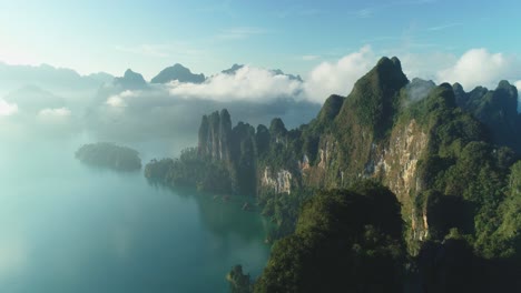 An-Aerial-View-Shows-Green-Mountain-Islands-Of-Khao-Sok-National-Park-In-Surat-Thani-Thailand-Among-Clouds