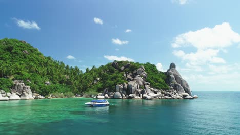 Boats-Are-Seen-Anchored-By-A-Palm-Treelined-Rocky-Coastline-Of-Ko-Tao-Thailand