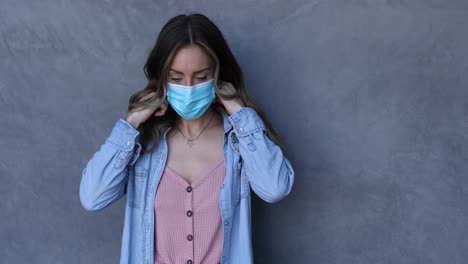 A-cleared-female-nurse-or-woman-with-mask-puts-on-a-mask-during-the-Covid19-coronavirus-pandemic-epidemic-1