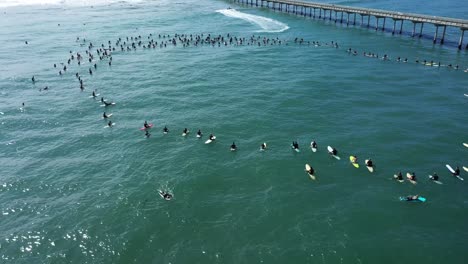 Vista-Aérea-over-surfers-in-circle-during-BLM-Black-Lives-Matter-Paddle-For-Freedom-gathering-in-California-6