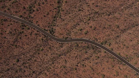 Aerial-straight-down-top-down-of-a-lonely-empty-mountain-road