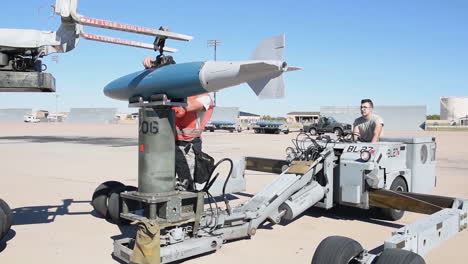 Bombs-Are-Loaded-Onto-An-American-B1B-Bomber-At-An-Air-Base-At-Night-In-Advance-Of-A-Bombing-Mission