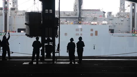 An-American-Aircraft-Carrier-Is-Resupplied-By-Helicopter-During-A-Replenishment-At-Sea-1