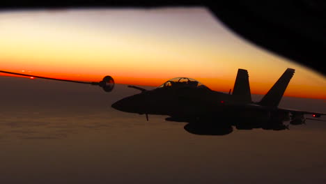 A-Midair-Jet-Refueling-Maneuver-Is-Conducted-By-The-Us-Air-Force-At-Sunset