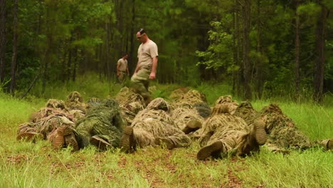 Soldiers-At-Fort-Bennings-Sniper-School-Crawl-Towards-A-Forest-In-Their-Ghillie-Suits