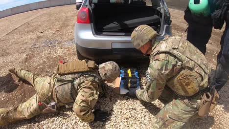 Us-Army-Eod-Specialists-And-Kosovo-Bomb-Squad-Members-Use-Special-Technology-On-Cars-that-Have-Been-Blown-Up
