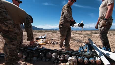 Us-Army-Eod-Techs-Go-Over-Spent-Rockets-In-A-Desert