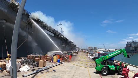 A-Helicopter-Fights-A-Fire-Aboard-Amphibious-Assault-Ship-Uss-Bonhomme-Richard-Dockside-At-Naval-Base-San-Diego-Ca-1