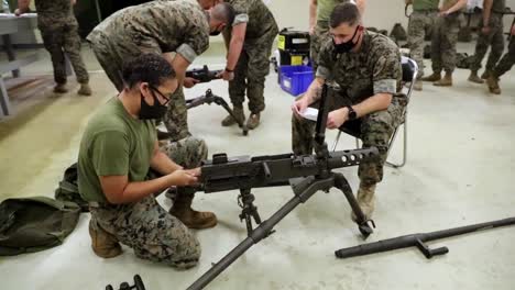 A-Female-Marine-With-Combat-Logistics-Battalion-4-Takes-A-Machine-Gun-Class-At-Camp-Kinser-Okinawa-Japan