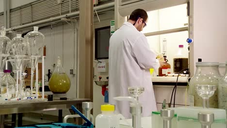 A-Scientist-In-The-Lab-Inspects-Crude-Oil-Samples-Derived-From-Algae