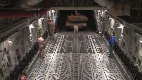 Fast-Motion-Shot-As-Airmen-Prepare-Secure-And-Transport-A-Usmc-M1A1-Abrams-Tank-To-Afghanistan-Aboard-A-C17-Globemaster