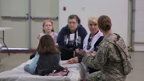 People-Take-Refuge-At-A-Red-Cross-Emergency-Shelter-During-A-Disaster