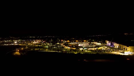 Time-Lapse-Sunset-Behind-A-Carnival-Or-Fair-Held-In-A-Mall-Parking-Lot-With-Crowds-And-Booths-And-Rides