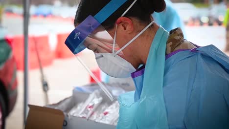 Covid19-Coronavirus-Patients-Are-Tested-At-A-Drive-Thru-Clinic-Gowns-Masks-And-Hand-Sanitizer-Shown-1