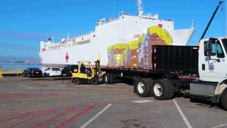 Surgical-Masks-And-Gowns-And-Other-Protective-Medical-Supplies-Are-Trucked-To-The-Us-Navy-Mercy-Hostpital-Ship-During-Covid19-Coronavirus-Outbreak-Epidemic-1