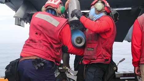 Sailors-On-the-Uss-Gerald-R-Ford-Load-Mk82-500-Lb-Inert-Bombs-And-Other-Ordnance-Onto-F/A-18-E-Super-Hornets