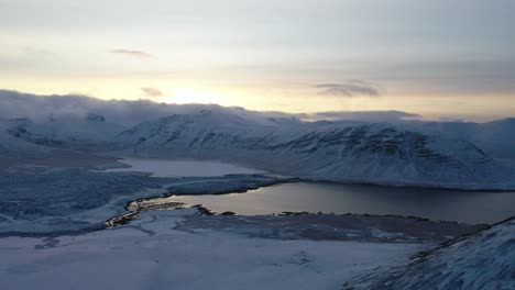 Aerial-of-a-wintry-Iceland-mountain-range-at-sunset