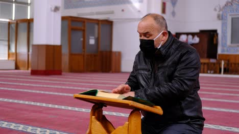 Middle-Age-Masked-Man-Reads-Quran-During-Ramadan