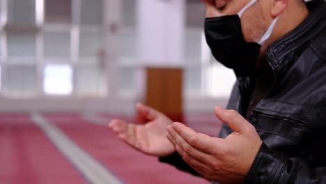 Man-raising-His-Hands-And-Praying-In-Mosque