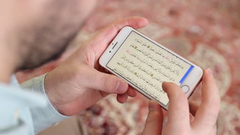 Muslim-Reading-Mobile-Quran-In-Mosque