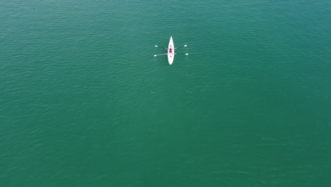 Two-Female-Rowing-Canoe-On-Sea