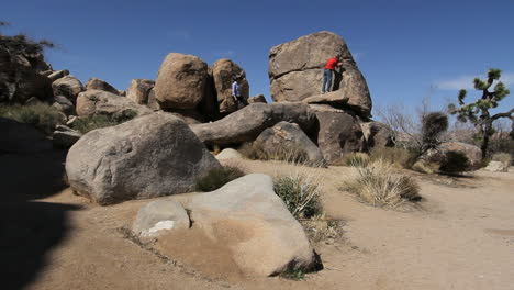 Joshua-Tree-National-Park-California-couple-climbing-on-rocks