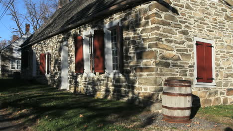 A-barrel-to-catch-rain-water-stands-by-an-old-stone-house-in-New-Paltz.