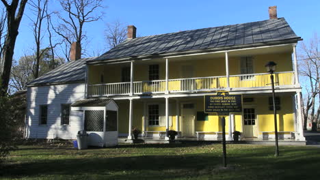 A-two-story-porch-runs-along-the-front-of-the-Du-Bois-house-in-New-Platz,-New-York.