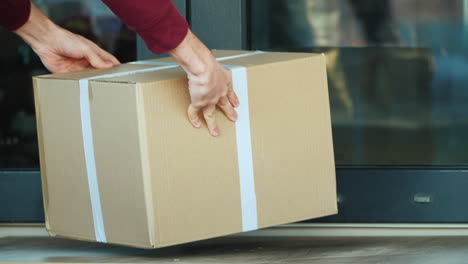 Courier-Delivers-Parcel-To-The-Door-Of-The-House