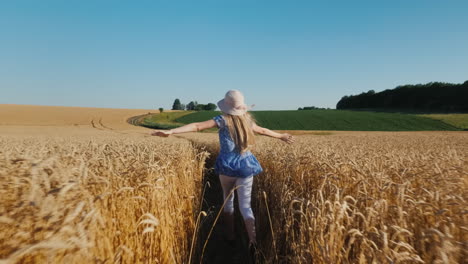Carefree-girl-runs-in-a-wheat-field