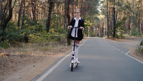 A-child-in-a-school-uniform-rides-a-scooter-through-the-park